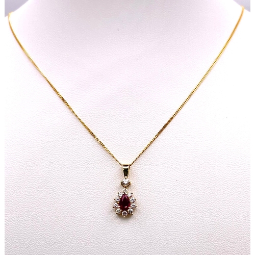 1723 - A 9K Gold, Ruby and Diamond Pendant on an 9K Gold Necklace. Teardrop ruby with a diamond halo. Penda... 