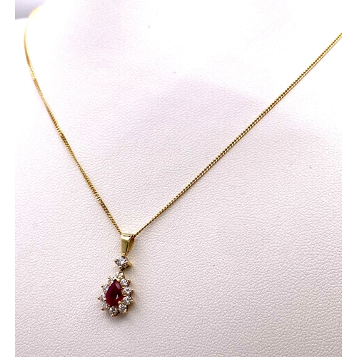 1723 - A 9K Gold, Ruby and Diamond Pendant on an 9K Gold Necklace. Teardrop ruby with a diamond halo. Penda... 