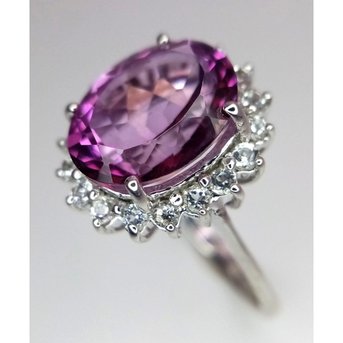 1720 - A 9K White Gold, Pink Stone (Possibly Tourmaline) and Diamond Halo. Size O. 5.16g total weight. Ref:... 