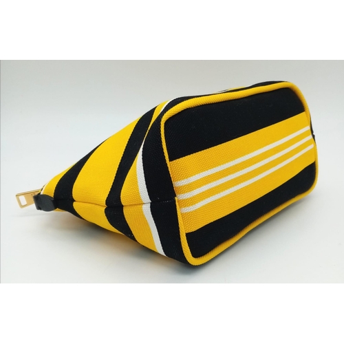 339 - A Prada Yellow, Black and White Pouch. Textile exterior, with gold tone hardware and top zip, and th... 