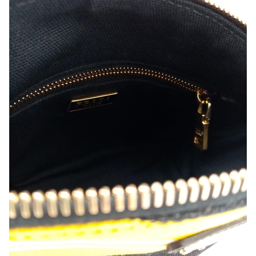 339 - A Prada Yellow, Black and White Pouch. Textile exterior, with gold tone hardware and top zip, and th... 