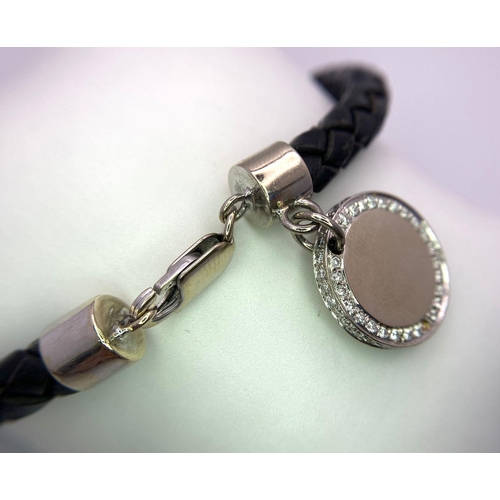 284 - A BLACK TWISTED LEATHER BRACELET WITH 18K WHITE GOLD ENDS AND CLASP PLUS AN 18K GOLD AND DIAMOND CHA... 