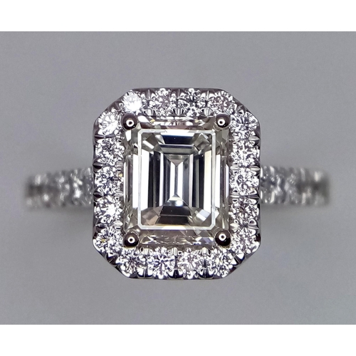 180 - A FABULOUS EMERALD CUT DIAMOND RING , A 1.29ct DIAMOND SET IN PLATINUM WITH A DIAMOND HALO AND SHOUL... 