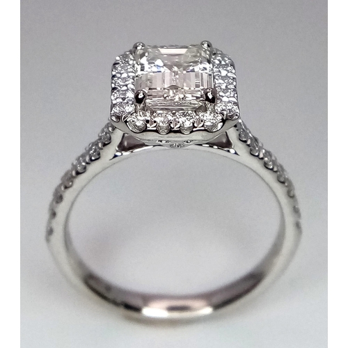 180 - A FABULOUS EMERALD CUT DIAMOND RING , A 1.29ct DIAMOND SET IN PLATINUM WITH A DIAMOND HALO AND SHOUL... 