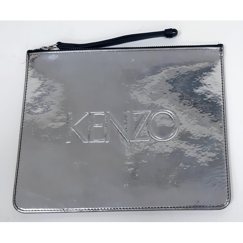 1214 - KENZO Reflective Sleeve Pouch.
Zip top with a large black leather zipper tag. Measures 24cm wide by ... 