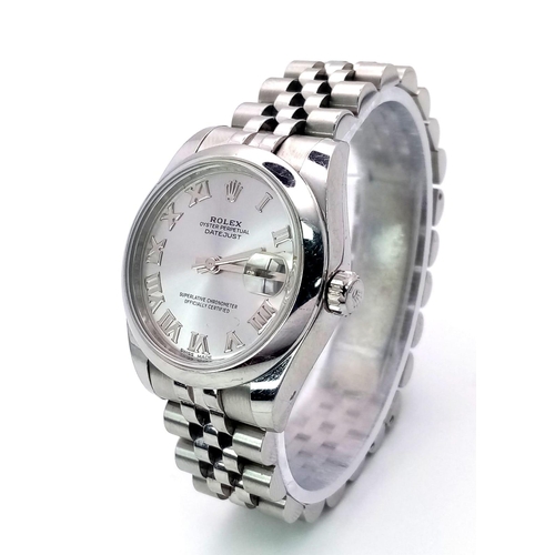 136 - A MID SIZE ROLEX PERPETUAL DATEJUST IN STAINLESS STEEL WITH SILVERTONE DIAL AND ROMAN NUMERALS .   3... 