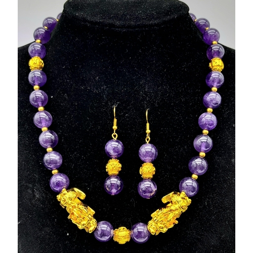 153 - A sophisticated, amethyst necklace with gold filled Chinese “pixiu” protective dogs (sometimes calle... 