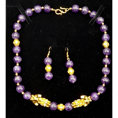 153 - A sophisticated, amethyst necklace with gold filled Chinese “pixiu” protective dogs (sometimes calle... 