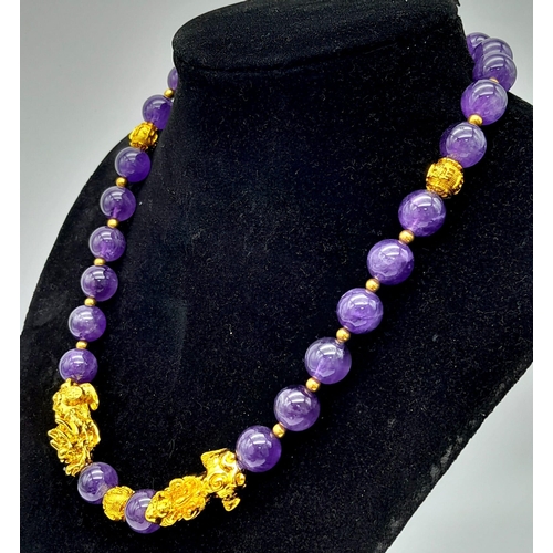 153 - A sophisticated, amethyst necklace with gold filled Chinese “pixiu” protective dogs (sometimes calle... 