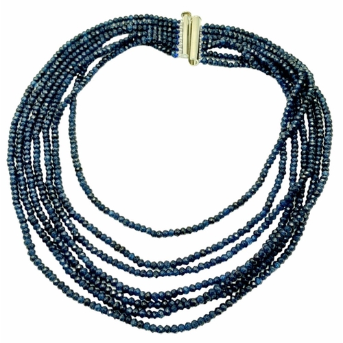 174 - A magnificent, seven row necklace with faceted dark blue sapphire rondelles. Length: 43-54 cm, weigh... 