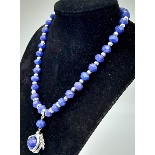 181 - A fashionable, multifaceted lapis lazuli necklace with an eagle’s claw pendant (symbolising power & ... 