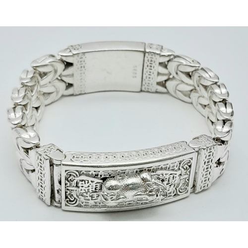 188 - Of special interest to Feng Shui followers, a gents, substantial, Chinese, silver, bracelet with a p... 