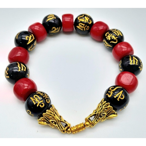 230 - An original “GOOD LUCK” necklace, bracelet and earrings set with natural red coral alternating with ... 