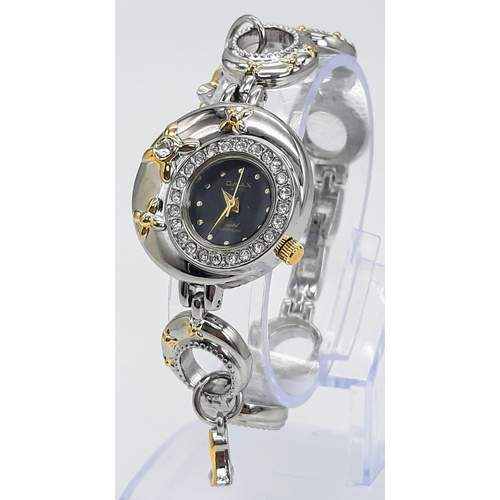 1799 - A Ladies Qmax Quartz Fashion Bracelet Watch.
16.5cm Length. Case measures 27mm Wide. New Battery Fit... 