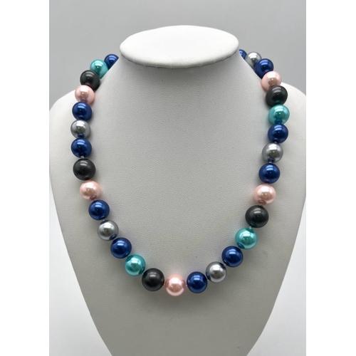 766 - A Multi-Coloured South Sea Pearl Shell Necklace. Metallic pink, blues and grey 12mm beads. Heart cla... 