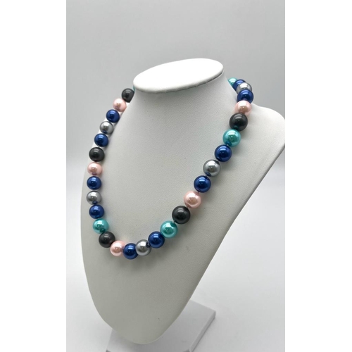 766 - A Multi-Coloured South Sea Pearl Shell Necklace. Metallic pink, blues and grey 12mm beads. Heart cla... 