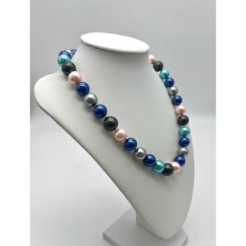 766 - A Multi-Coloured South Sea Pearl Shell Necklace. Metallic pink, blues and grey 12mm beads. Heart cla... 