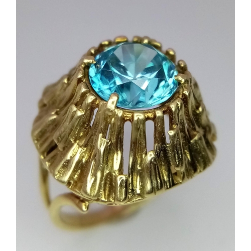 333 - A Vintage 14K Yellow Gold and Ice Blue Zircon Ring. A hypnotising central stone at the Apex of a Gol... 