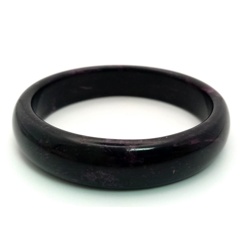 488 - A Shades of Purple Jade Bangle. 6cm inner diameter. 14mm width.