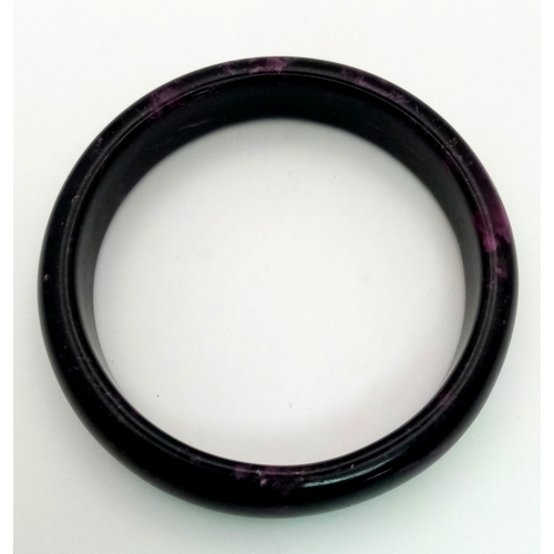 488 - A Shades of Purple Jade Bangle. 6cm inner diameter. 14mm width.