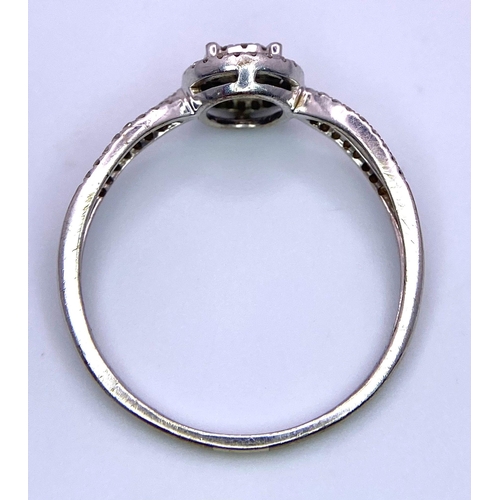 116 - A 9K White Gold Diamond Double Halo Ring. Central diamond with double diamond halo and shoulder acce... 
