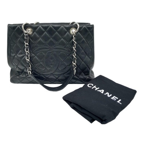 124 - Black Chanel GST Bag.
Quilted leather stitched in diamond pattern. Silver toned hardware and typical... 