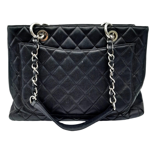 124 - Black Chanel GST Bag.
Quilted leather stitched in diamond pattern. Silver toned hardware and typical... 
