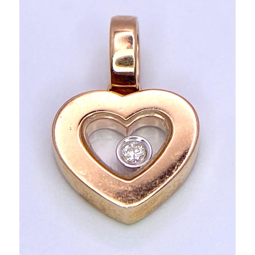 130 - An 18K Rose Gold Heart Pendant with a 0.10ct Floating Diamond. 15mm. 1.85g total weight.