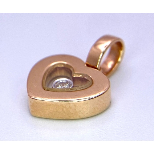 130 - An 18K Rose Gold Heart Pendant with a 0.10ct Floating Diamond. 15mm. 1.85g total weight.