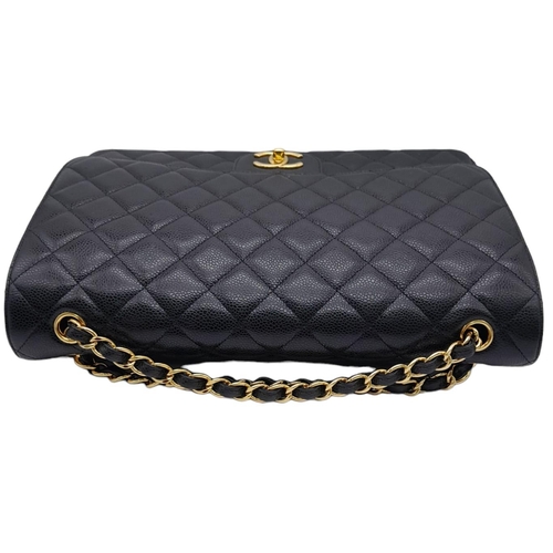 23 - Black Chanel Maxi Bag.
Quilted leather stitched in diamond pattern. Gold toned hardware and typical ... 