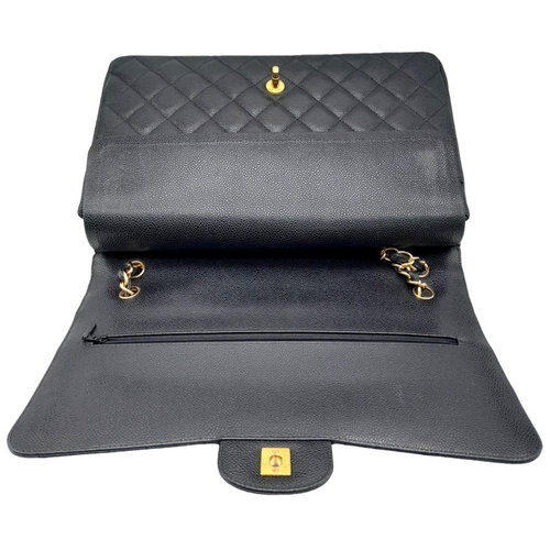 23 - Black Chanel Maxi Bag.
Quilted leather stitched in diamond pattern. Gold toned hardware and typical ... 
