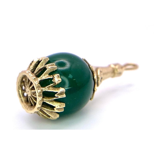 256 - A Vintage 9K Yellow Gold and Green Jade Ball Pendant. 3cm.
5.34g total weight.
