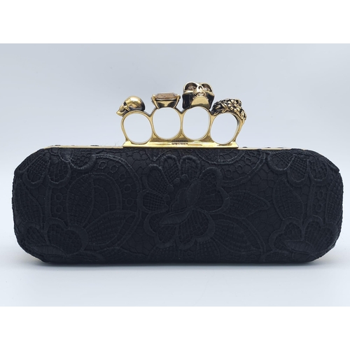 265 - Alexander McQueen Skull & Gem Ring Clutch.
Black floral embroidered exterior with gold tone hardware... 