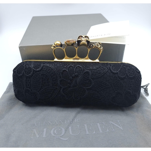 265 - Alexander McQueen Skull & Gem Ring Clutch.
Black floral embroidered exterior with gold tone hardware... 