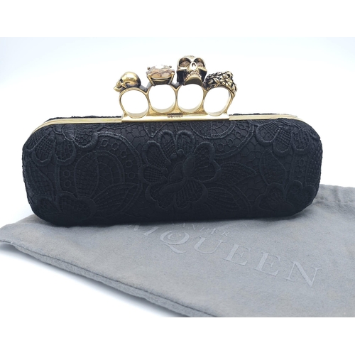 265 - Alexander McQueen Skull & Gem Ring Clutch.
Black floral embroidered exterior with gold tone hardware... 