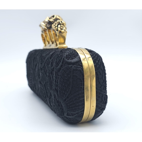 265 - Alexander McQueen Skull & Gem Ring Clutch.
Black floral embroidered exterior with gold tone hardware... 