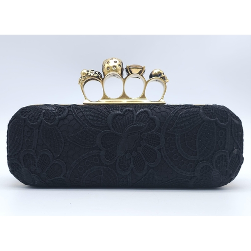 265 - Alexander McQueen Skull & Gem Ring Clutch.
Black floral embroidered exterior with gold tone hardware... 