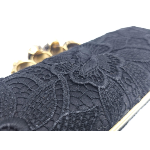 265 - Alexander McQueen Skull & Gem Ring Clutch.
Black floral embroidered exterior with gold tone hardware... 