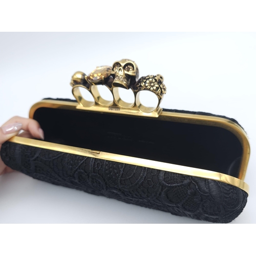 265 - Alexander McQueen Skull & Gem Ring Clutch.
Black floral embroidered exterior with gold tone hardware... 