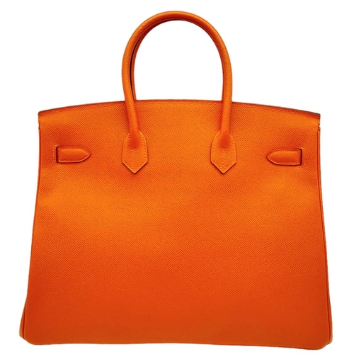 30 - Hermès Orange Togo Birkin Handbag. 
Iconic Orange paired with gold toned hardware is a brilliant pop... 
