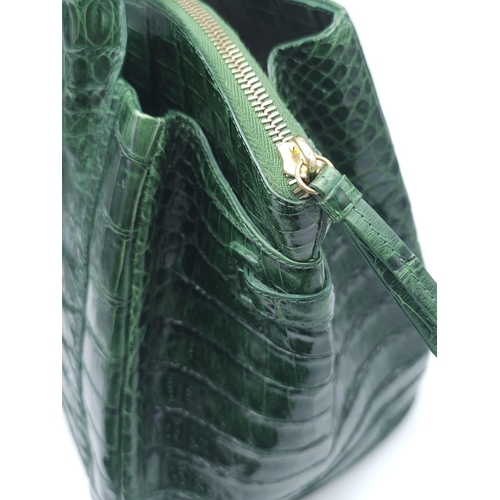 110 - Nancy Gonzalez Crocodile Handbag.
Rich, emerald green crocodile leather exterior with gold tone hard... 