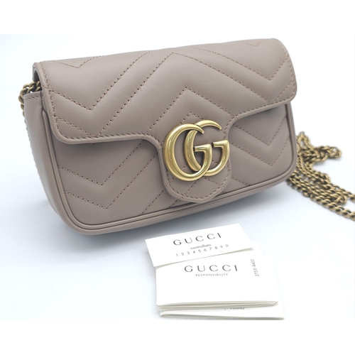 193 - A Gucci Mocha Marmont Mini Crossbody Bag. Matelassé leather exterior, with gold toned hardware and c... 