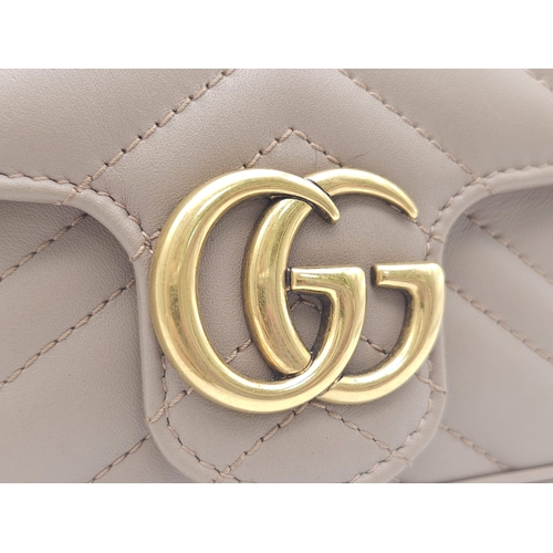 193 - A Gucci Mocha Marmont Mini Crossbody Bag. Matelassé leather exterior, with gold toned hardware and c... 