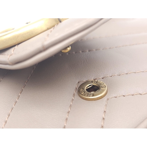 193 - A Gucci Mocha Marmont Mini Crossbody Bag. Matelassé leather exterior, with gold toned hardware and c... 