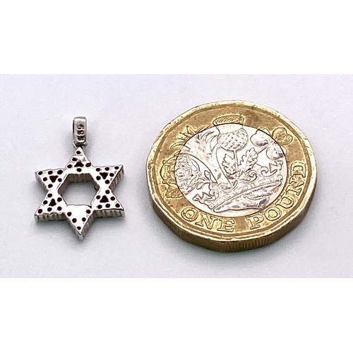 284 - A 14K White Gold and Diamond Star of David Pendant. 2cm. 1.41g total weight.