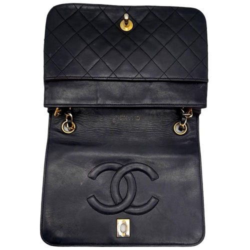 82 - Black Chanel Handbag.
Quilted leather stitched in diamond pattern. Gold & Silver toned hardware with... 