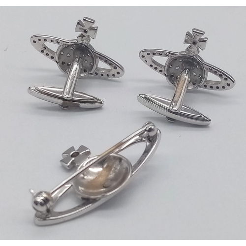 262 - An 18 K white gold VIVIENNE WESTWOOD HARDCORE DIAMOND pair of cufflinks and brooch set with the icon... 