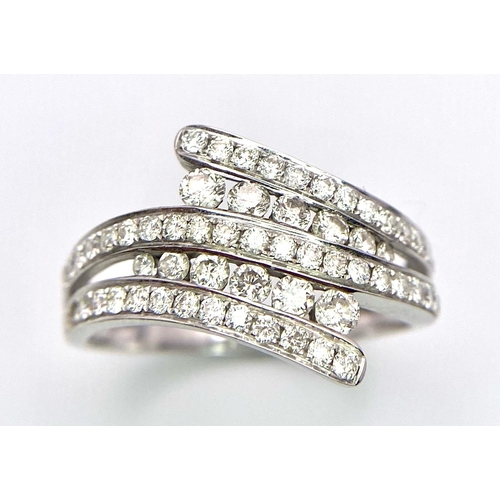 307 - A very attractive 18 K white gold ring with numerous round cut diamonds on paired and twisted design... 