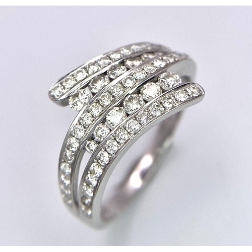 307 - A very attractive 18 K white gold ring with numerous round cut diamonds on paired and twisted design... 