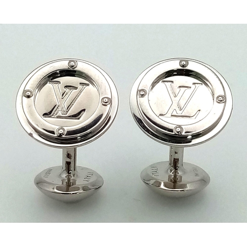 403 - A white metal (untested) LOUIS VUITTON pair of cufflinks in their original designer wallet. REF: 147... 